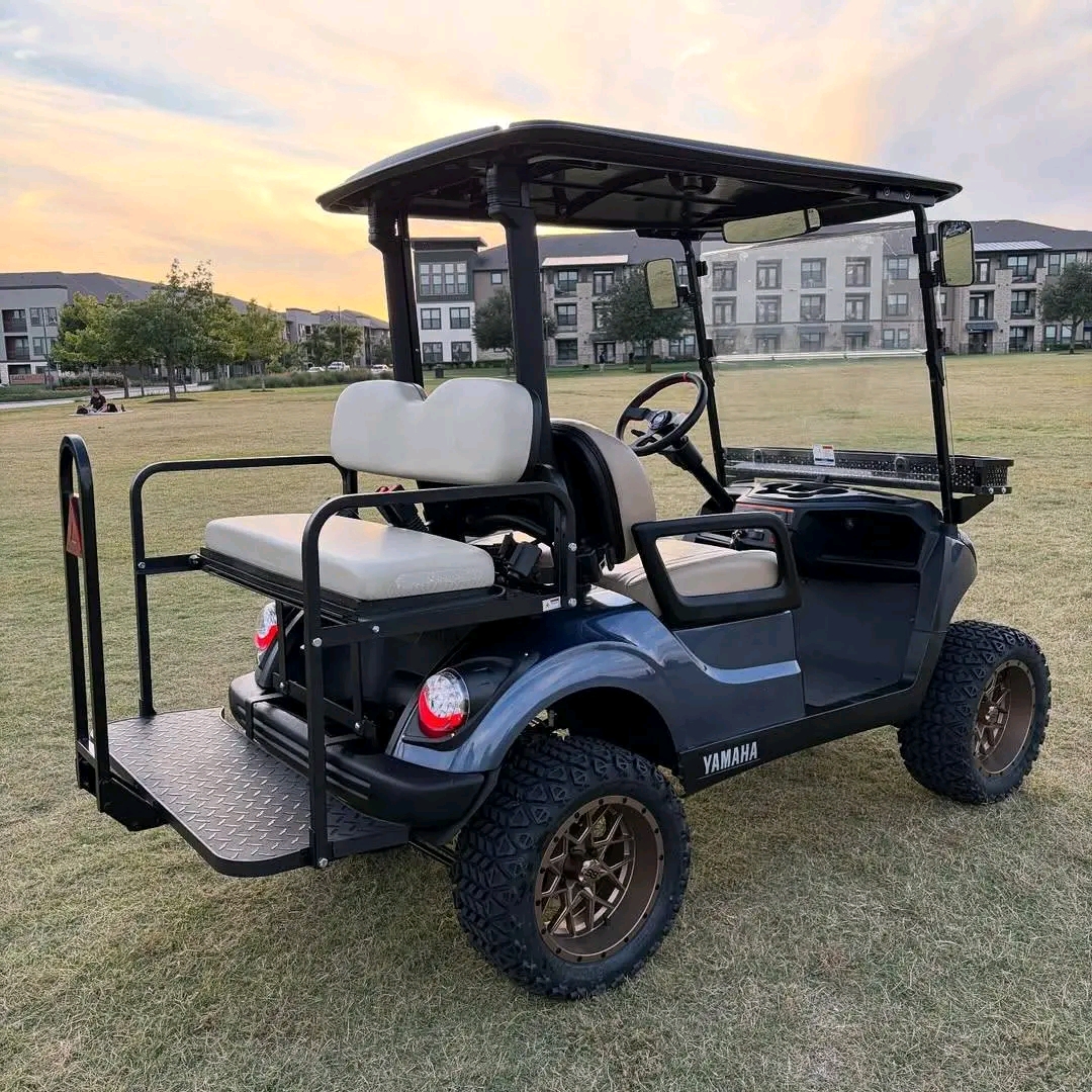 Yamaha Drive2 -custom-built with a lift kit, off-road tires on bronze/copper aftermarket wheels, tan diamond-stitched seating, dark gunmetal wrap, front cargo basket