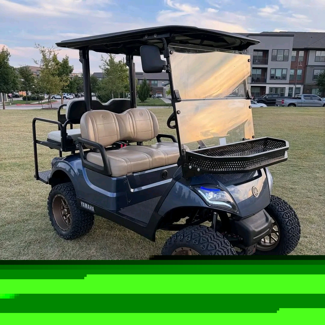 Yamaha Drive2 -custom-built with a lift kit, off-road tires on bronze/copper aftermarket wheels, tan diamond-stitched seating, dark gunmetal wrap, front cargo basket